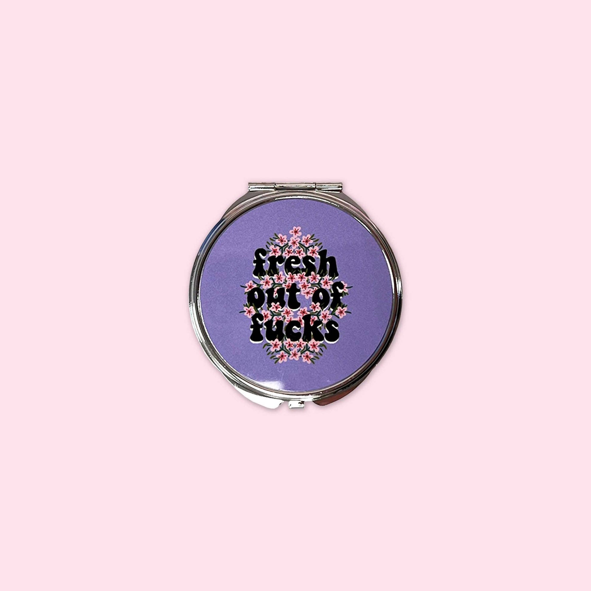 Small mirror compact with the words Fresh out of Fucks.