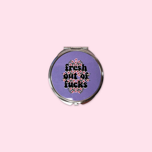 Small mirror compact with the words Fresh out of Fucks.