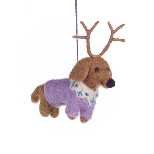 Decorative ornament of a dog with antlers wearing a sweater on a white background