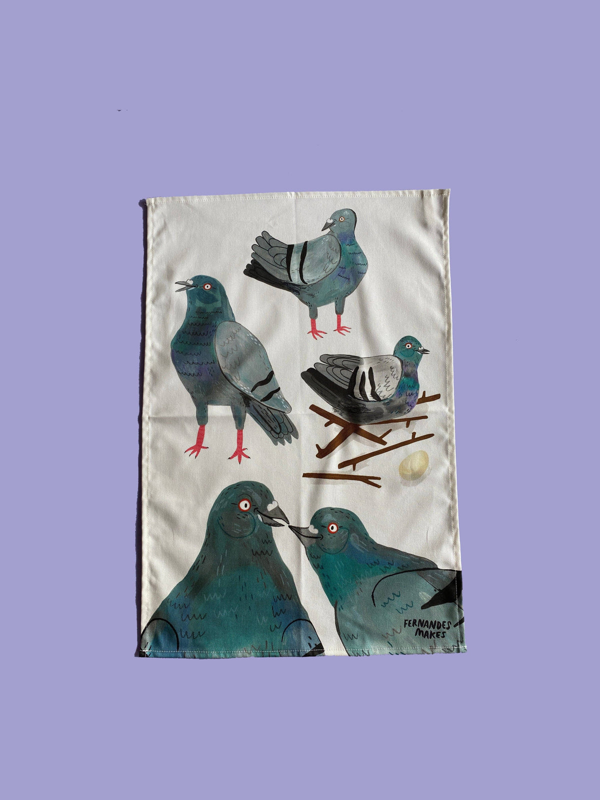 Tea towel with pigeon illustrations on a purple background