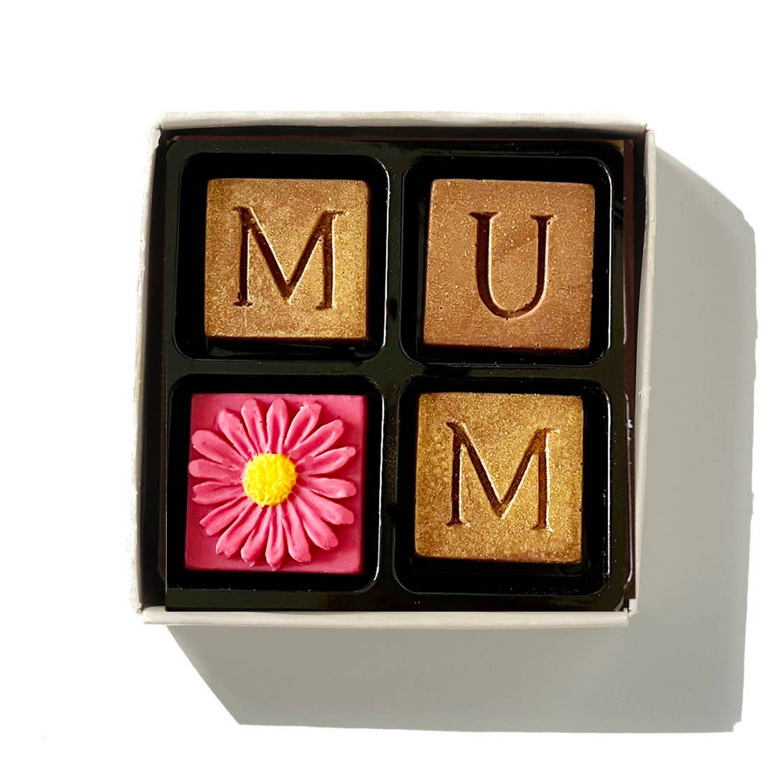 Chocolate blocks with 'MUM' and a pink flower in a box