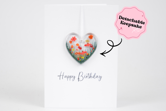 Heart-shaped detachable keepsake with floral design on a white card with 'Happy Birthday' text.