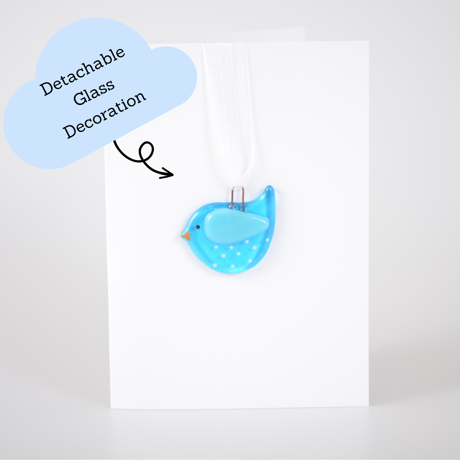 Blue bird-shaped decoration with detachable glass on a white background