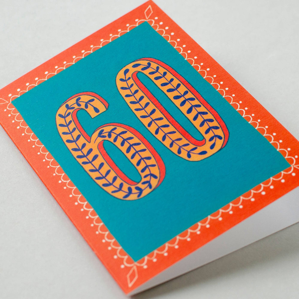 Greeting card with decorative number '60' on a teal background with an orange border.