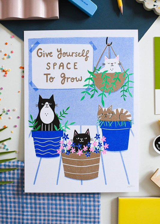 Card with cartoon cats in pots and plants, with text 'Give Yourself Space to Grow' on a colorful background.