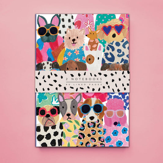 Set of two notebooks with colorful animal designs on a pink background
