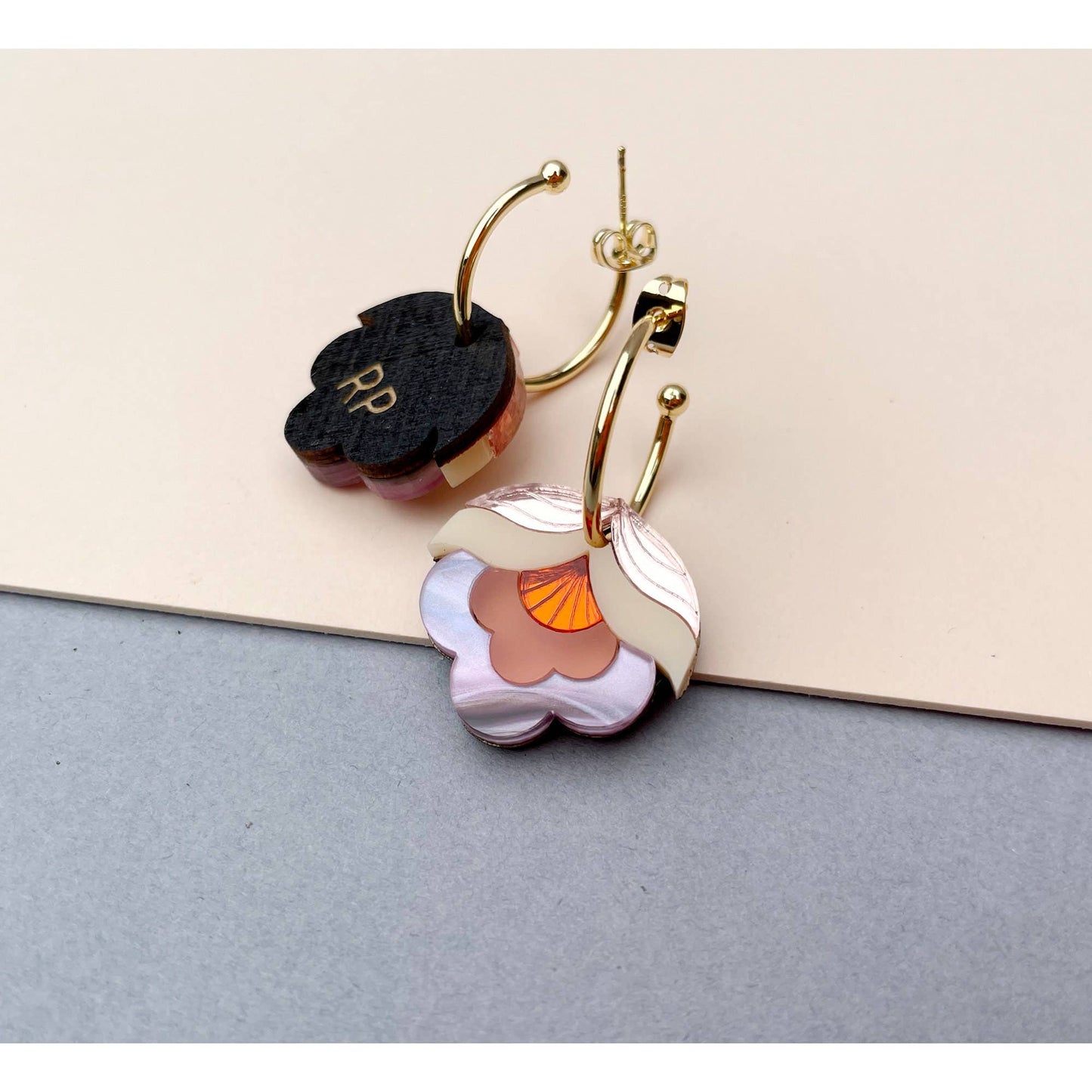 Pair of floral earrings on a textured surface