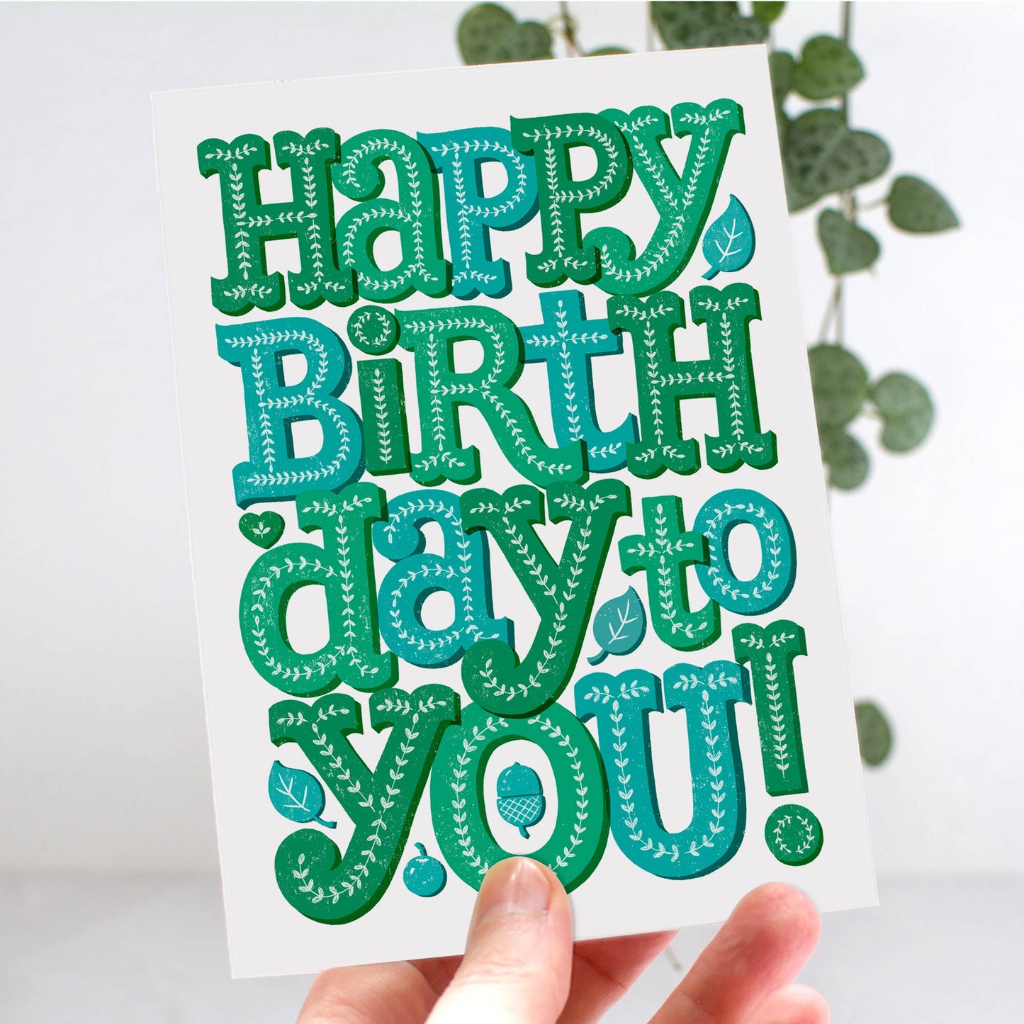 Birthday Card. Blank inside. Decorated text in Green and blue reads Happy Birthday You.