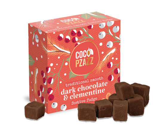 Box of Coco Pzazz dark chocolate and Clementine fudge with fudge pieces displayed in front.