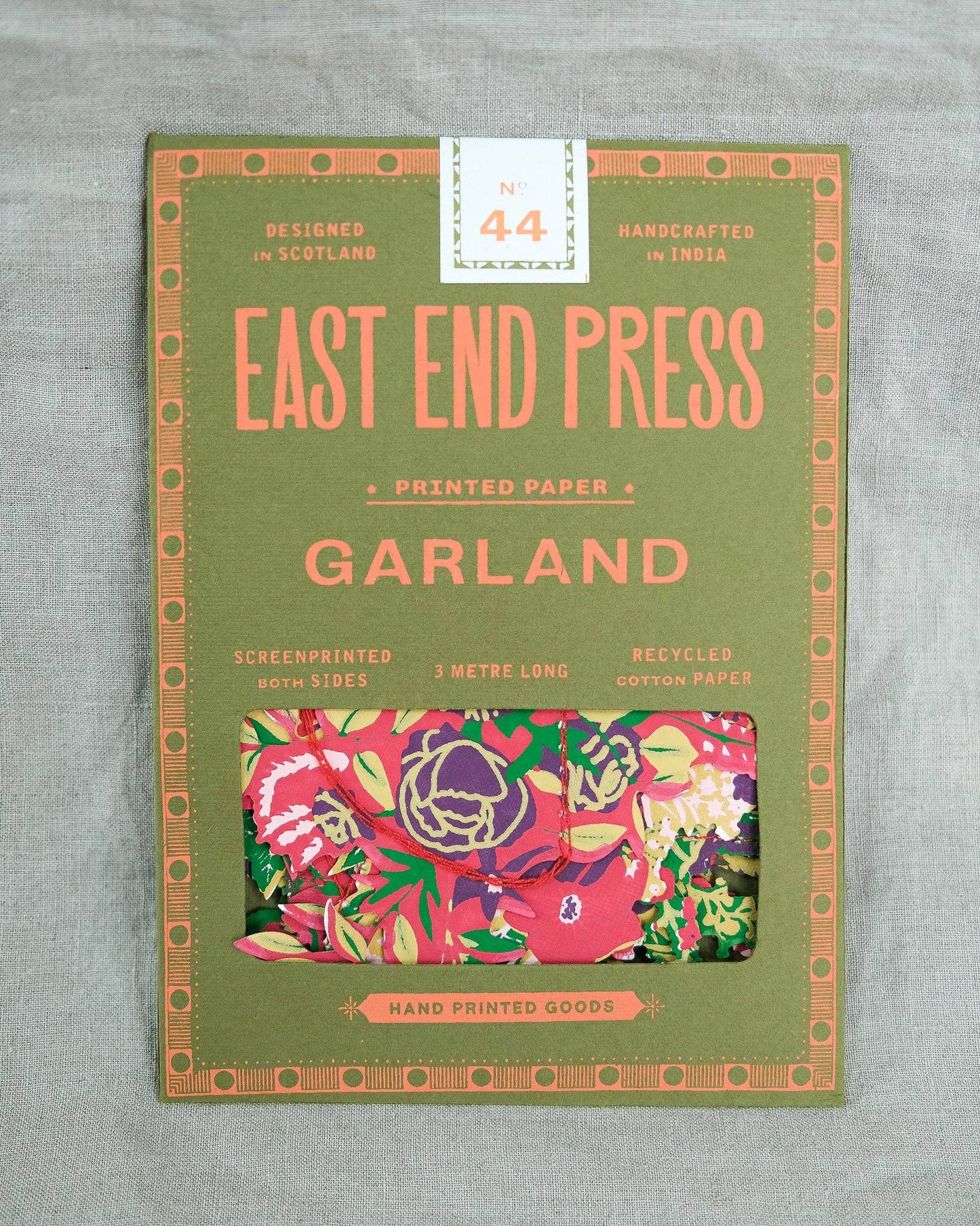 Packaging of East End Press printed paper with floral design on a gray background