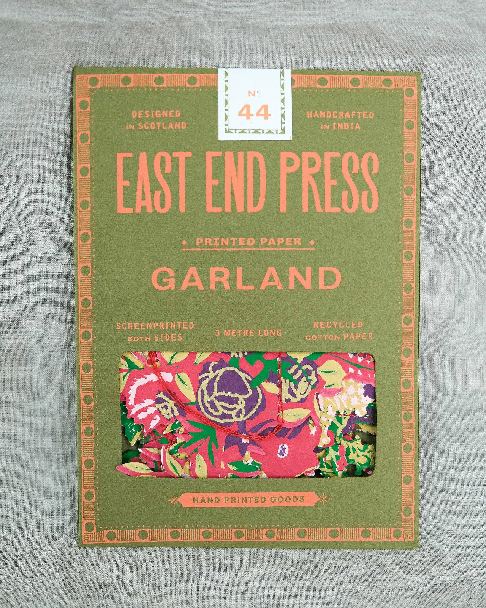 Packaging of East End Press printed paper with floral design on a gray background