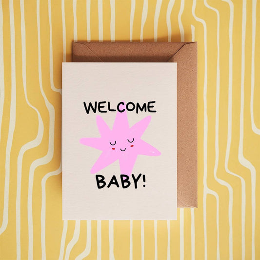 welcome baby card against yellow background.