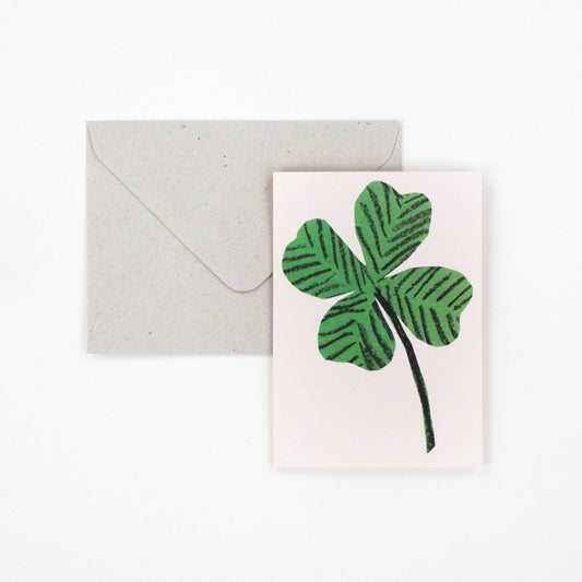 Small greetings card with a 4 leaf clover on a white background.