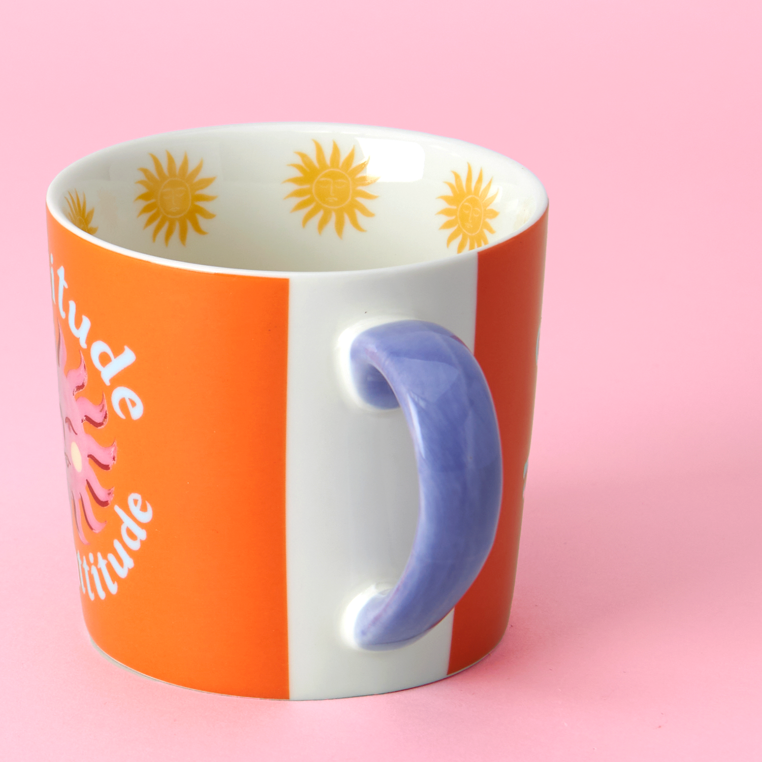 Colorful mug with sunflower pattern on a pink background