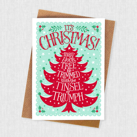 Christmas Card.  Blank inside.  Its Christmas may your tree be trimmed with the tinsel of triumph.  A festive red Christmas tree with green background.