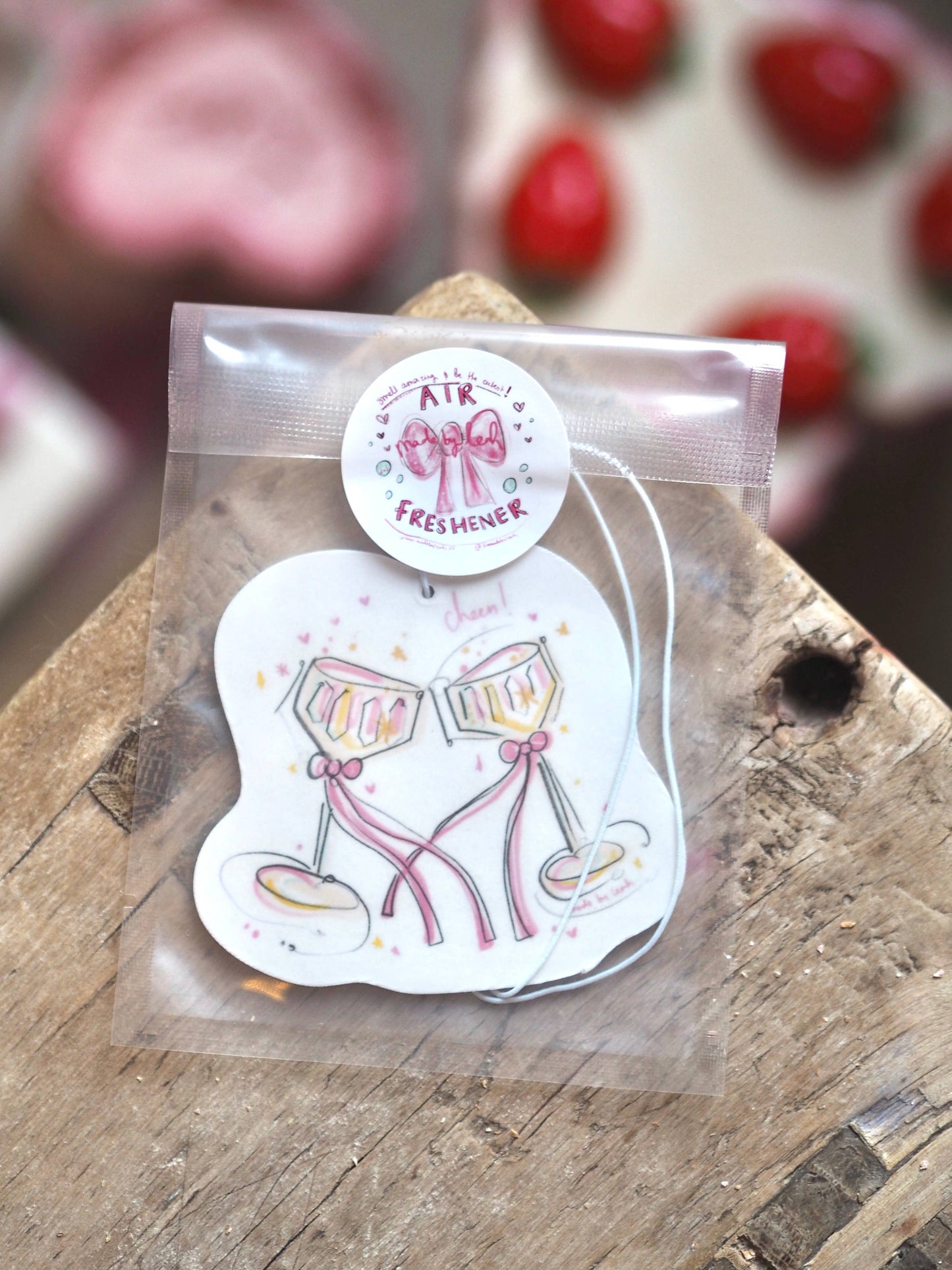 Air freshener with cartoon design on a wooden surface