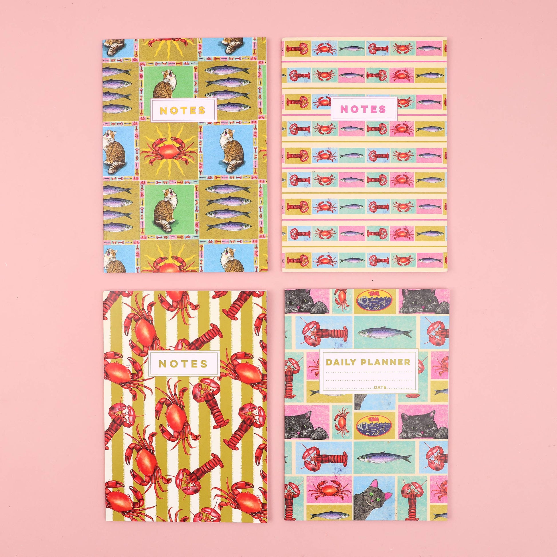 Set of four notebooks with colorful animal-themed designs on a pink background