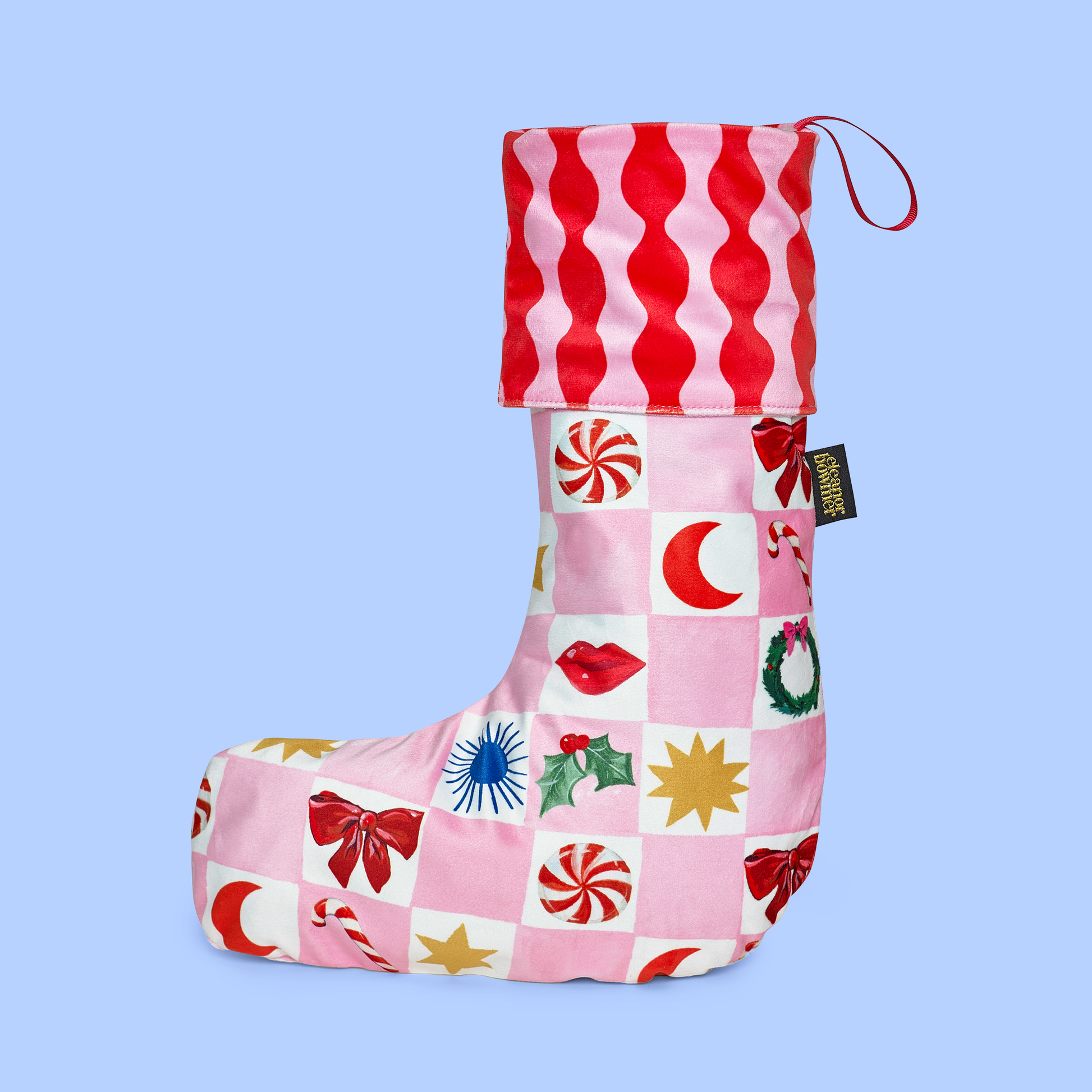 Colorful Christmas stocking with various patterns on a light blue background