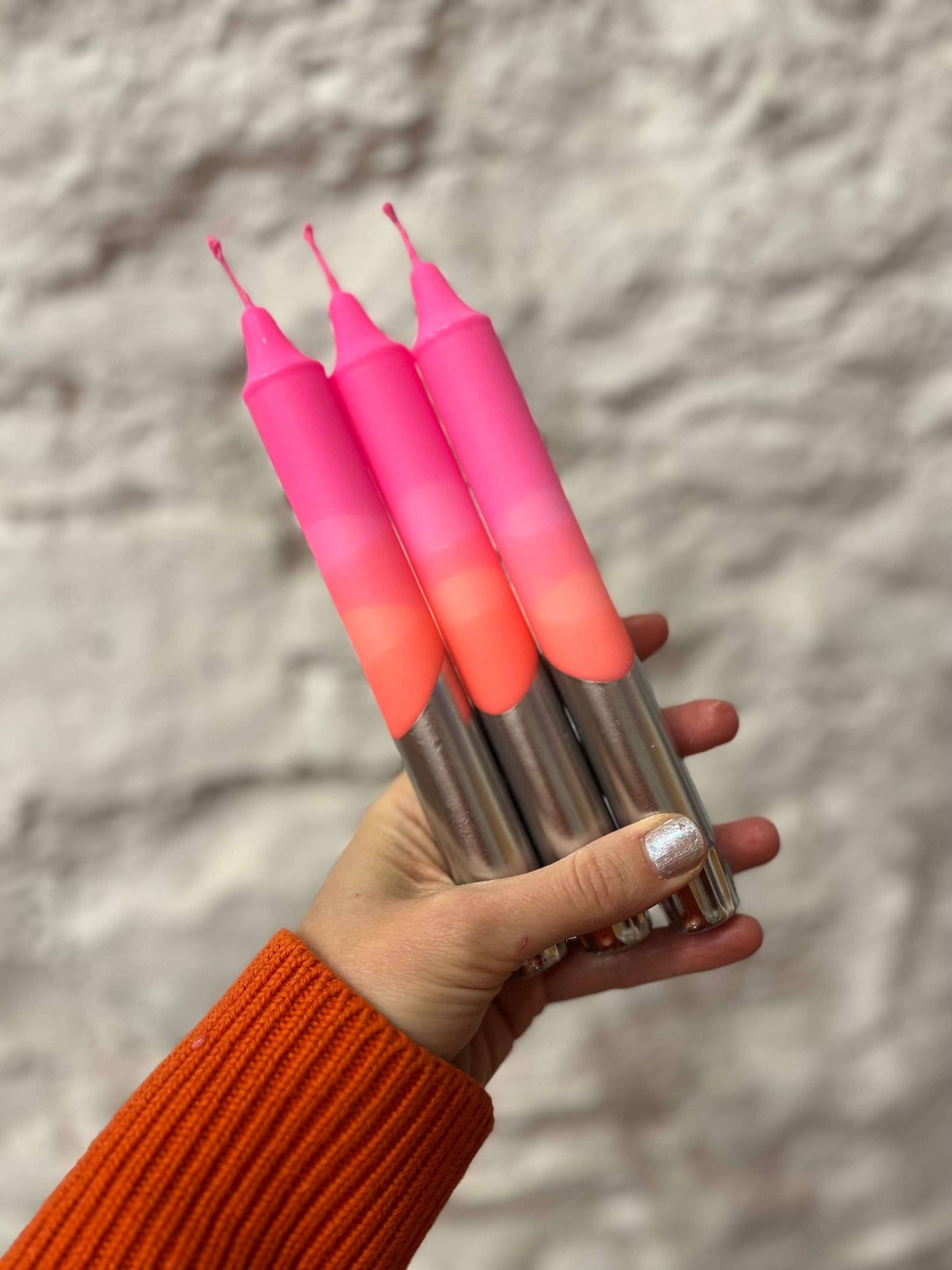 Bright pink. orange, gold dipped table candle.