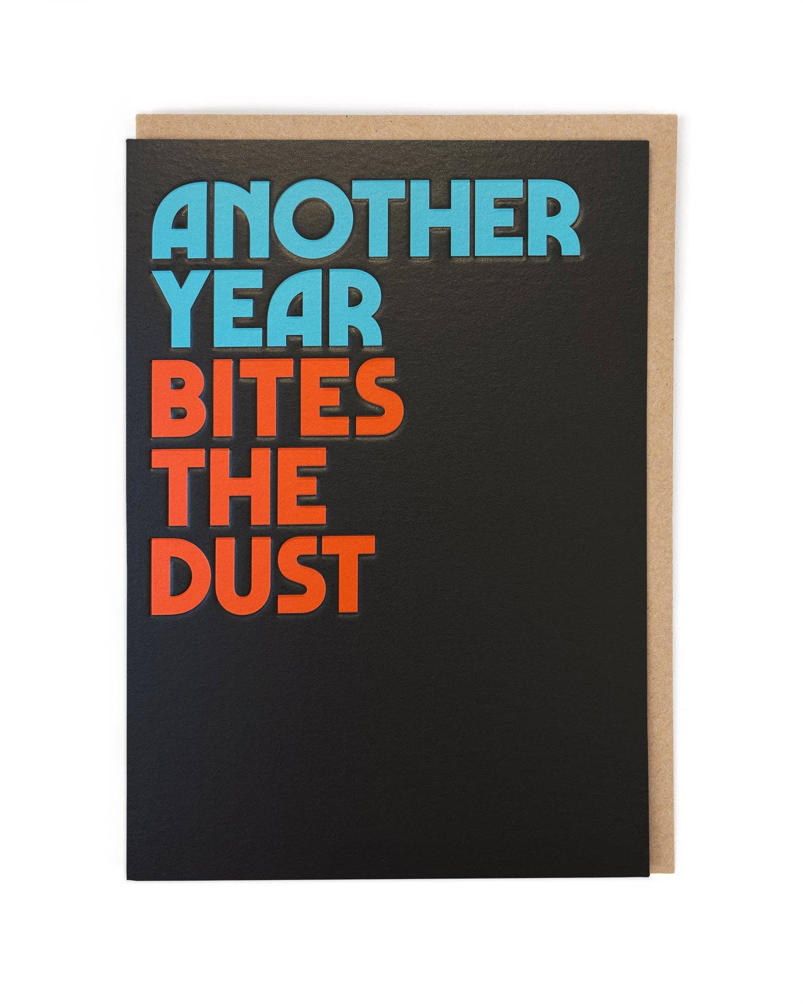 Greeting card with text 'Another Year Bites The Dust' on a black background