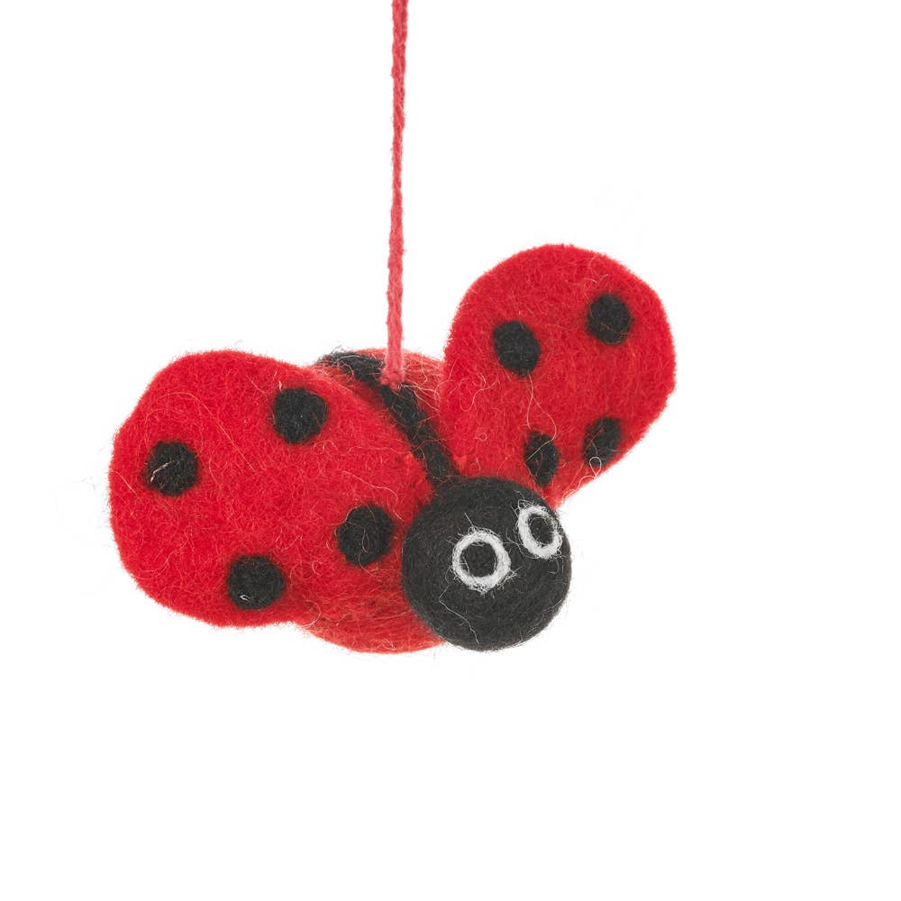 Red ladybug ornament with black spots on a white background