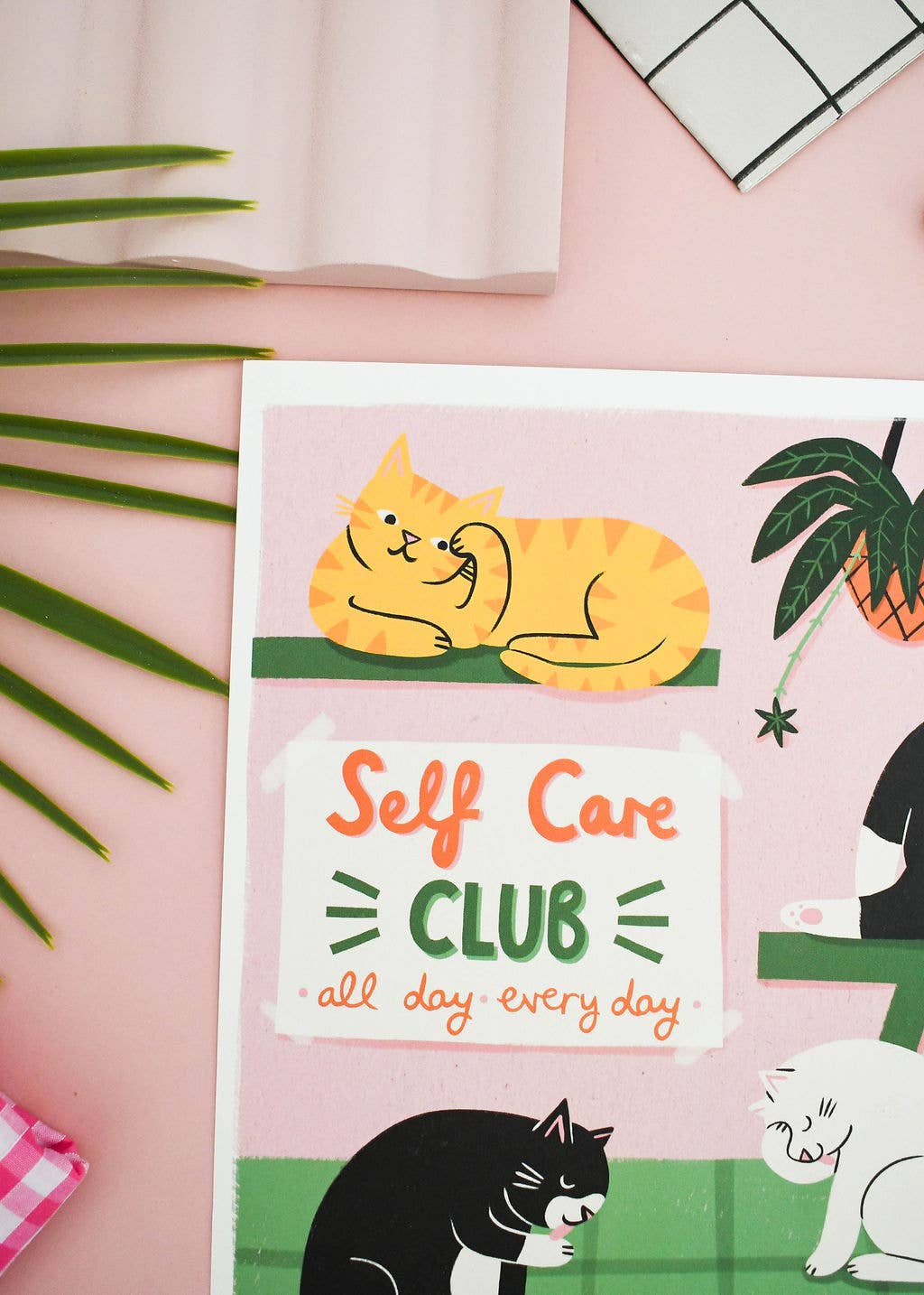 Card with cartoon cats and 'Self Care Club' text on a pink background