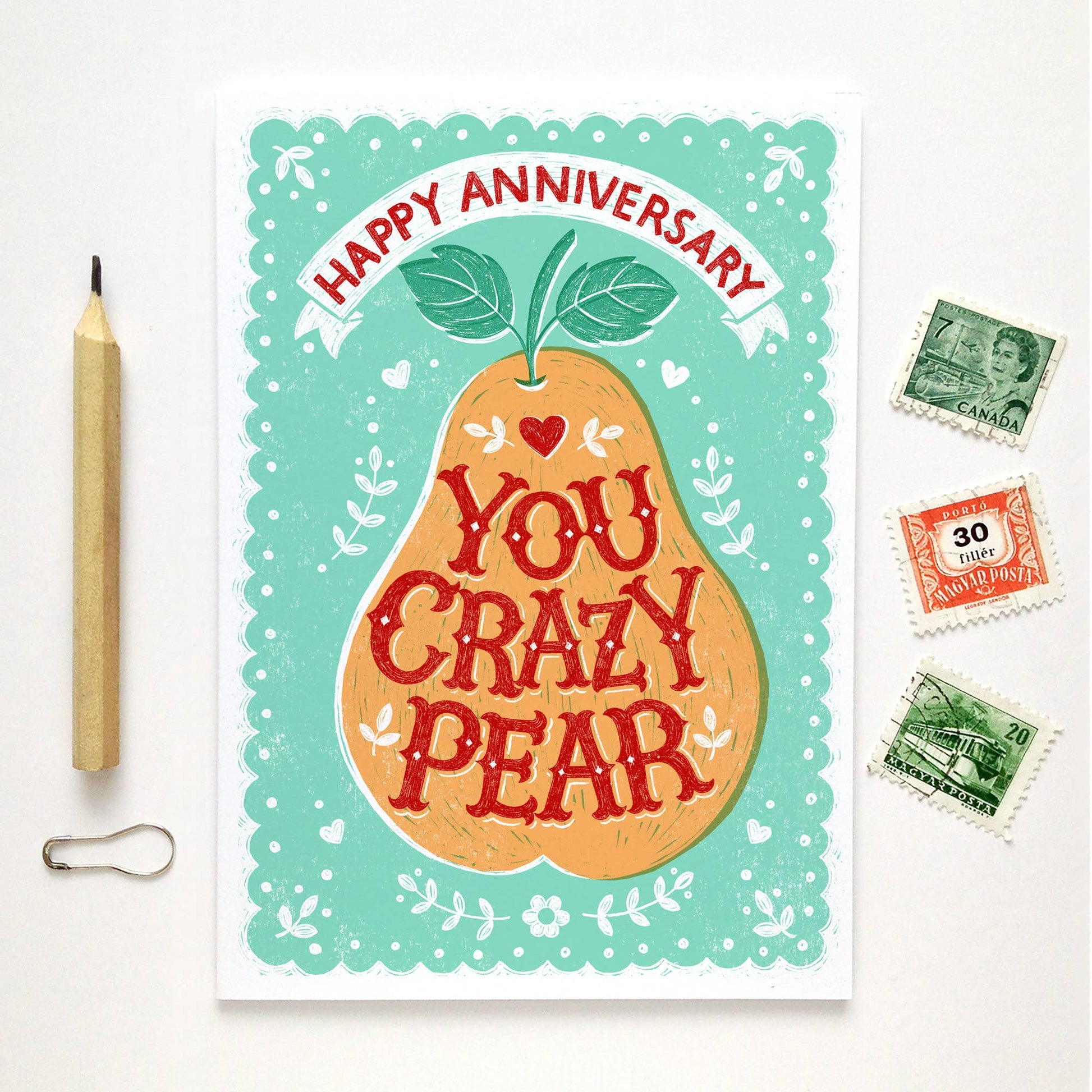 Anniversary Card.  An orange pear with teal patterned background.  Text reads Happy Anniversary.  Text in pear reads You Crazy Pear.