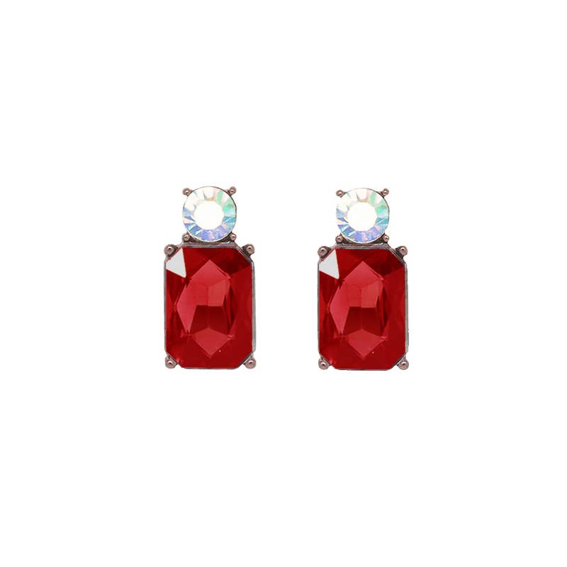 Pair of red gemstone earrings with clear gemstones on a white background