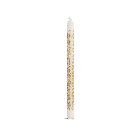 A single white taper candle with gold printed text and decorative motifs, standing upright on a clean white background.