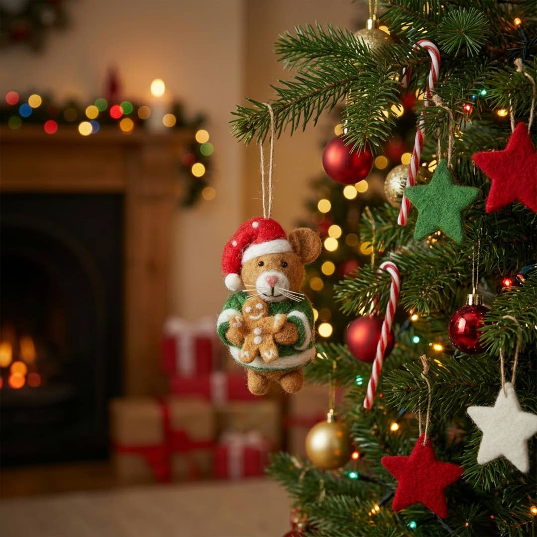 Decorated Christmas tree with ornaments, including a teddy bear with a Santa hat and gingerbread man, in a festive room.
