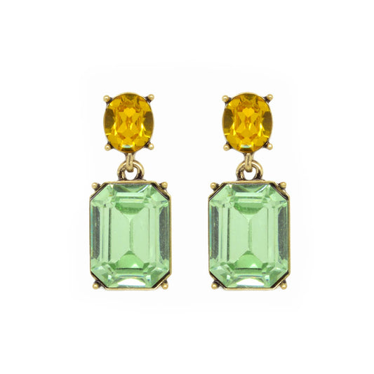 Pair of earrings with yellow and green gemstones on a white background