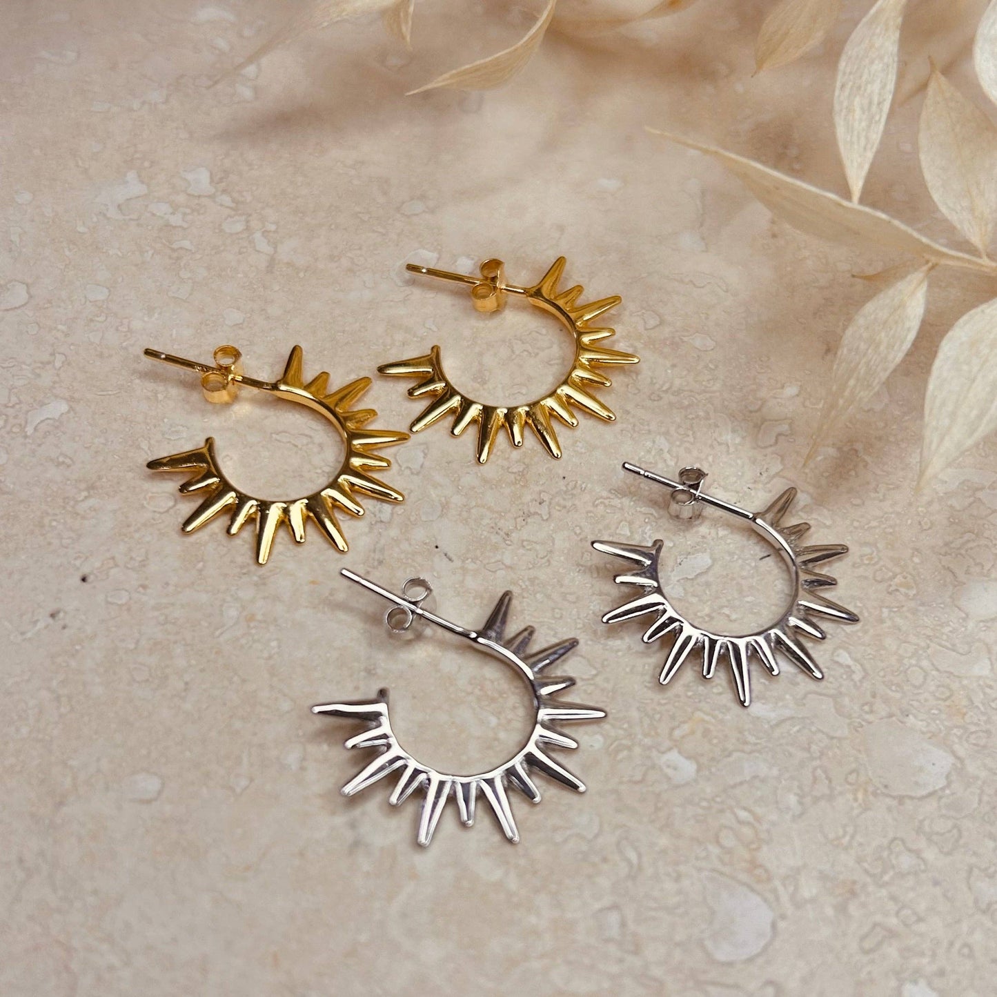 Mini gold or silver stud hoops with replicating sun rays.