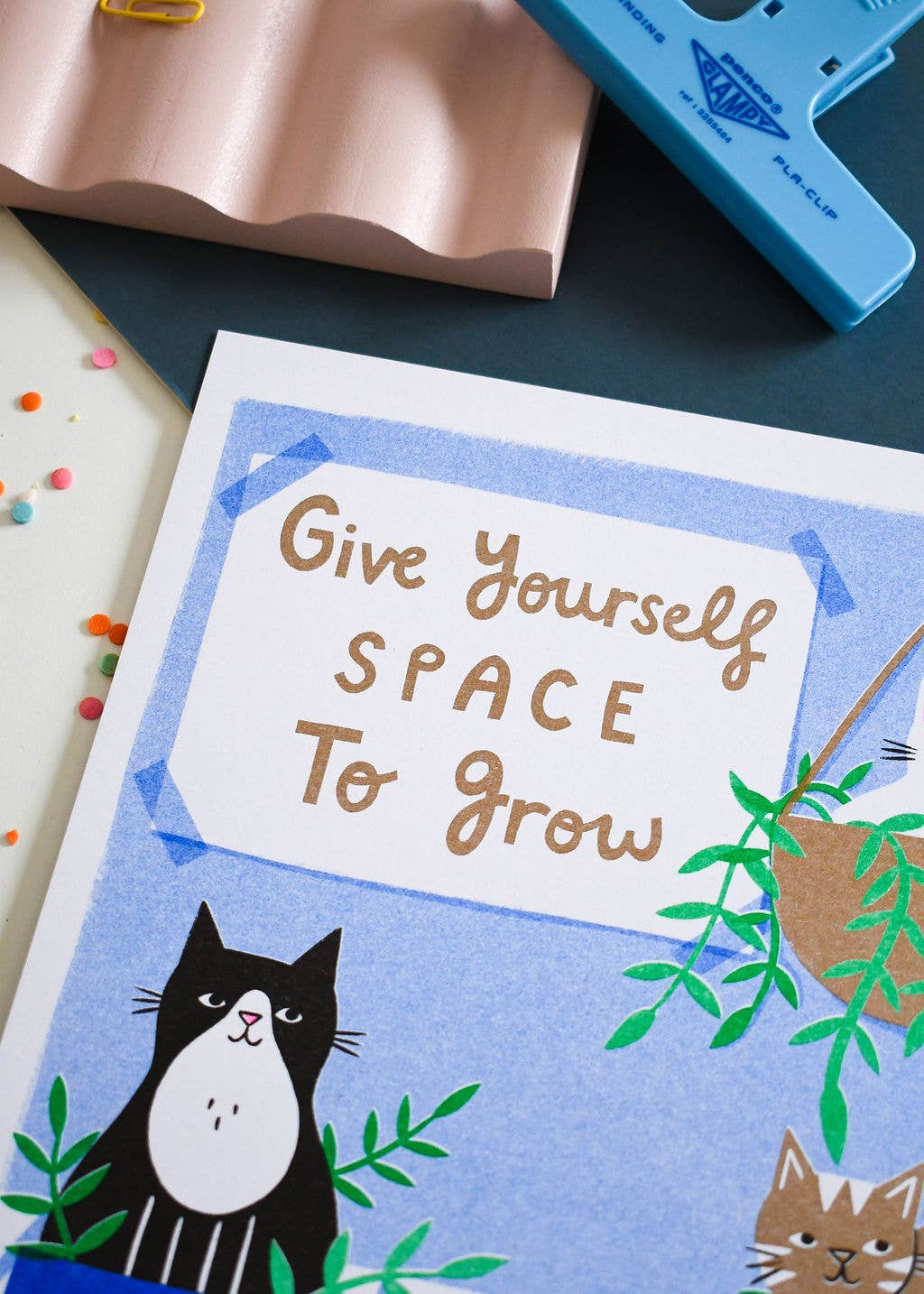Card with a cat illustration and motivational text on a blue background
