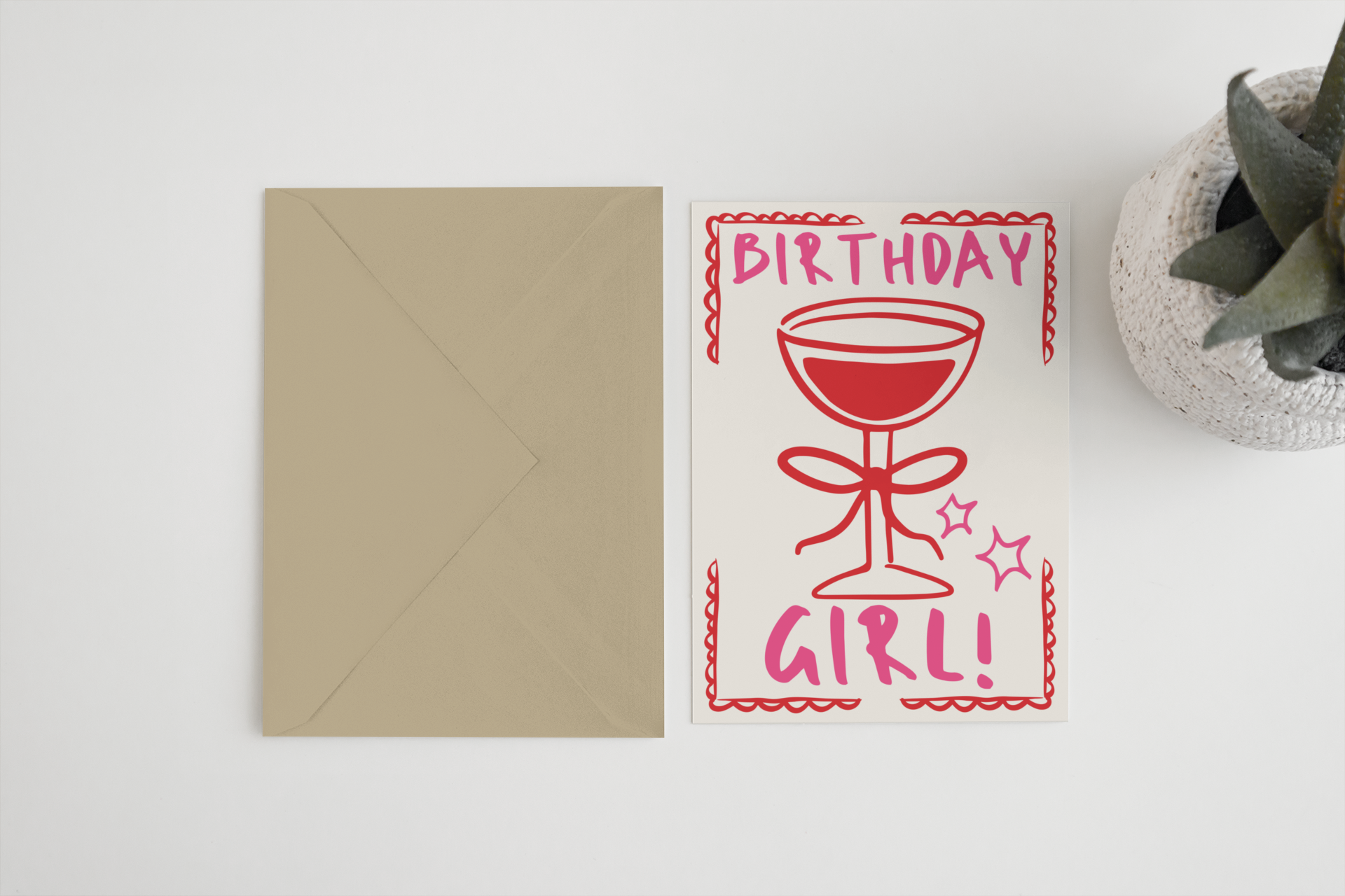 Birthday card with red text and envelope on a white surface