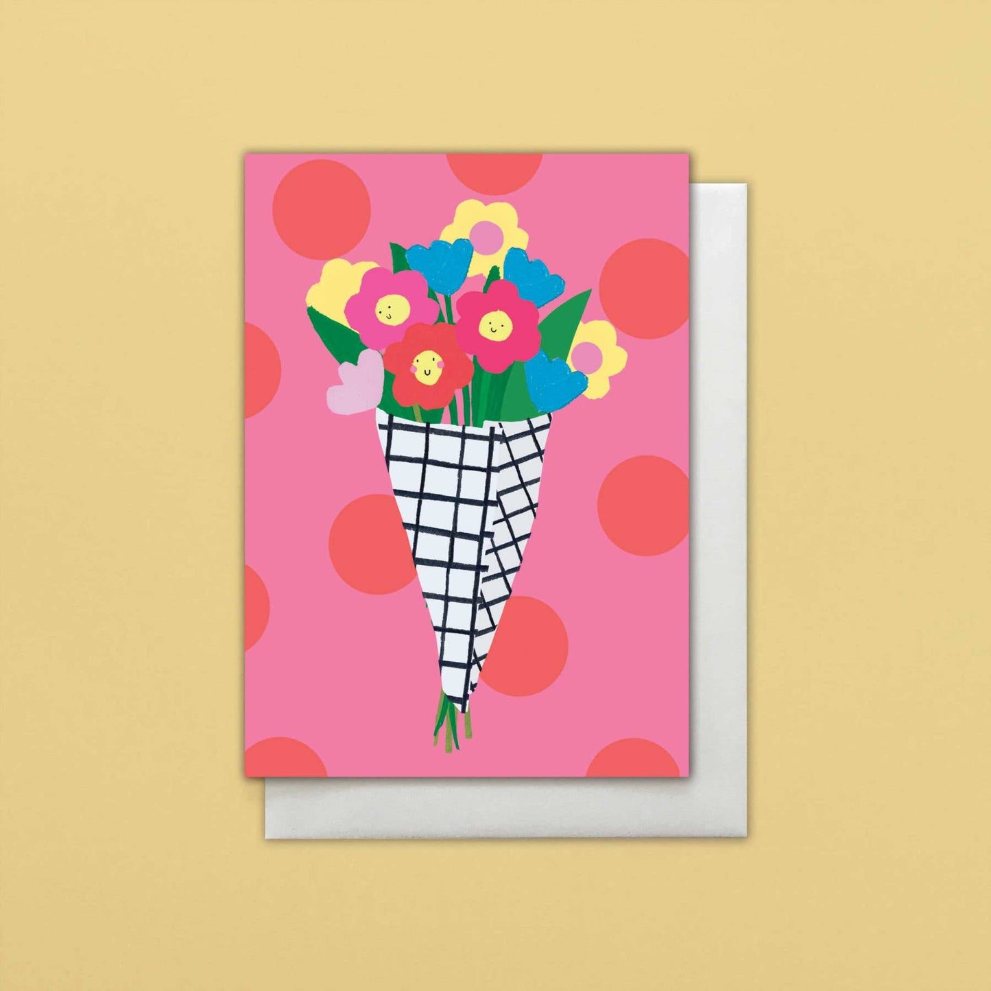 Greeting card with colorful flowers in a vase on a pink polka dot background