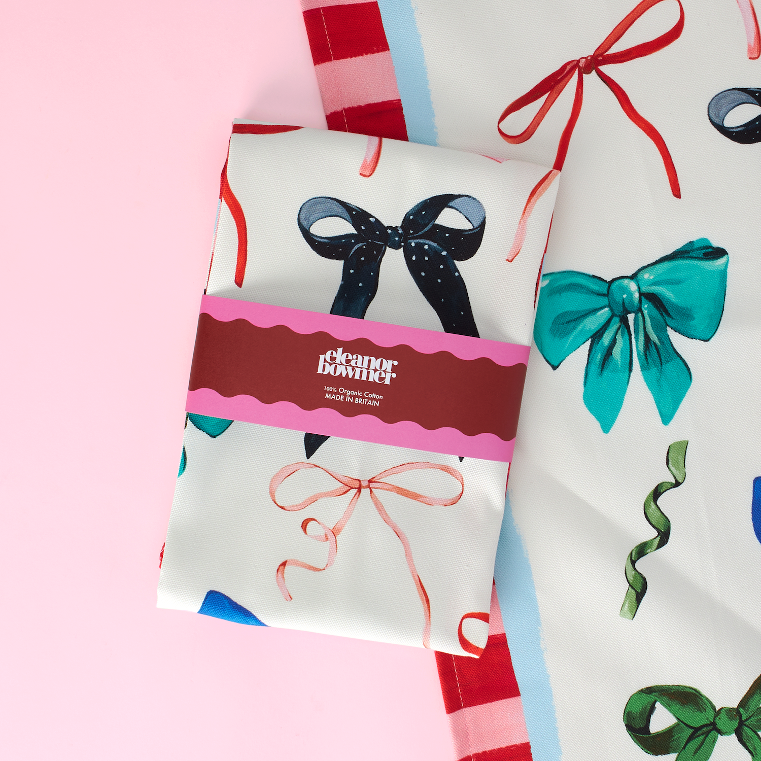 Gift wrap paper with colorful bows on a pink background