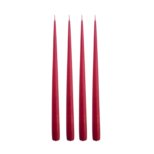 Four red taper candles standing upright in a row against a plain white background.