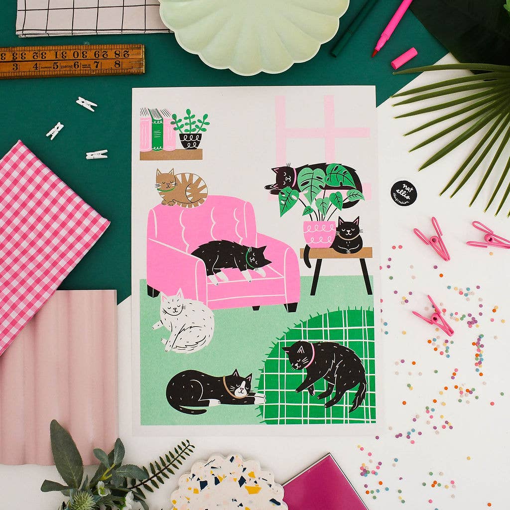 Illustration of cats on a pink chair and green floor with decorative items around