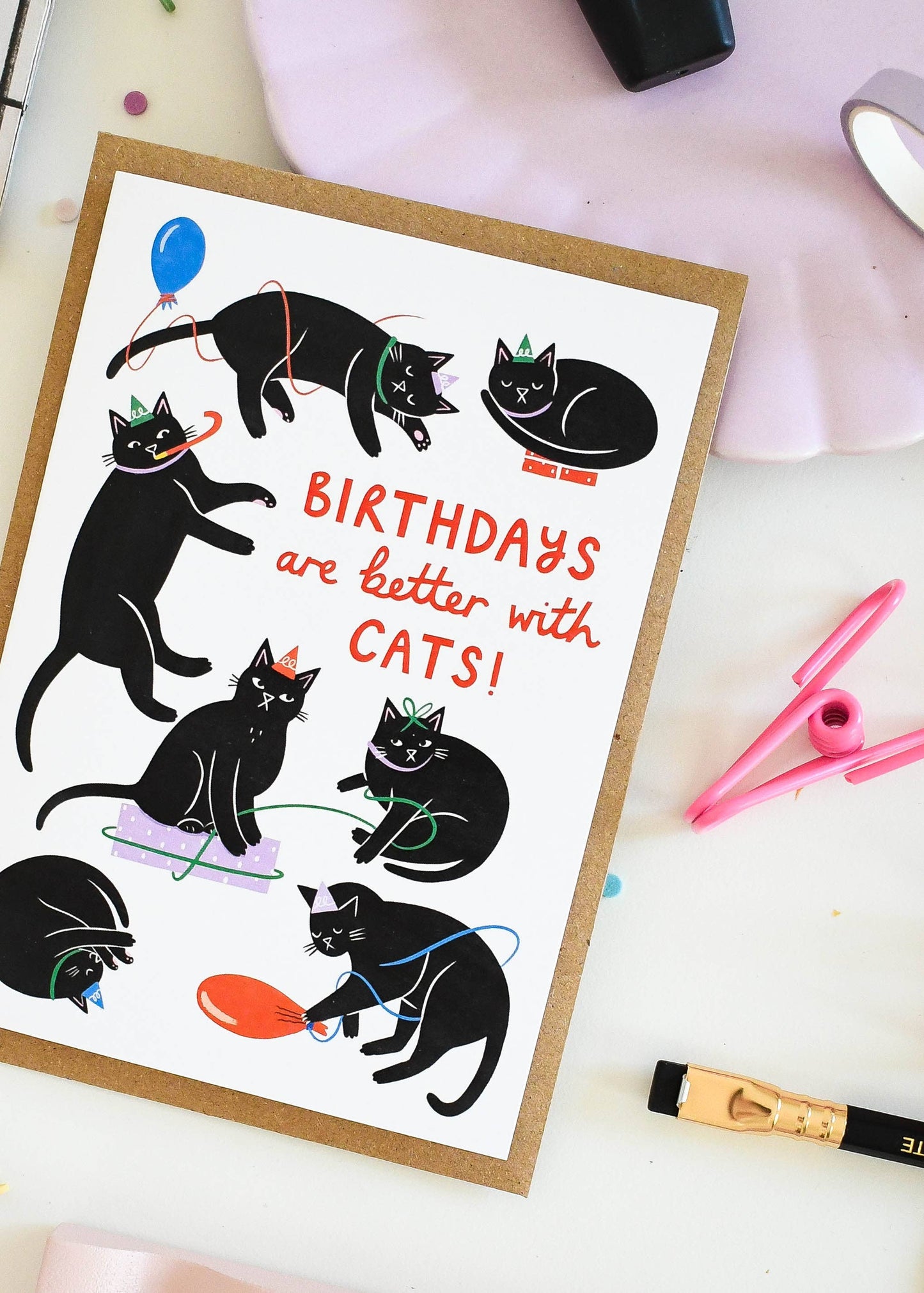 Card with black cats and 'Birthdays are better with cats!' text on a white surface.