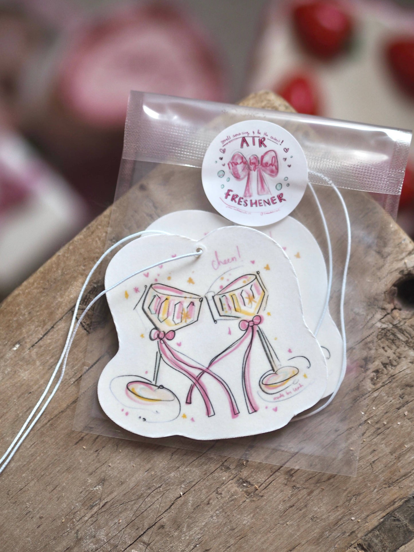 Air freshener with champagne glass design on a wooden surface