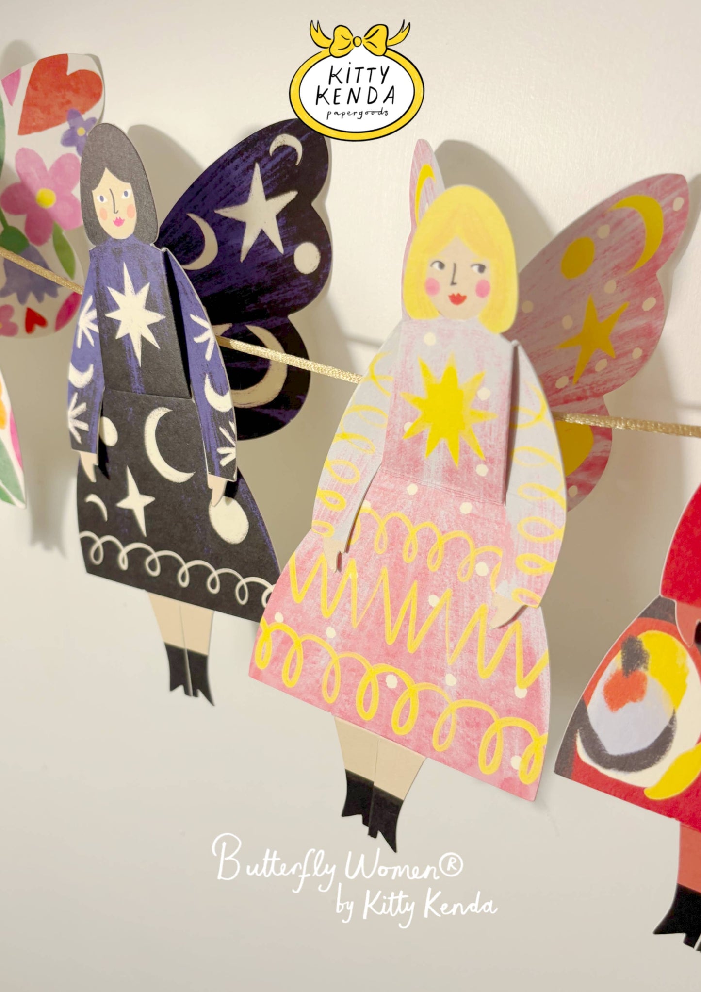 Colorful paper dolls with butterfly wings and dresses, featuring the brand 'Kitty Kenda'.