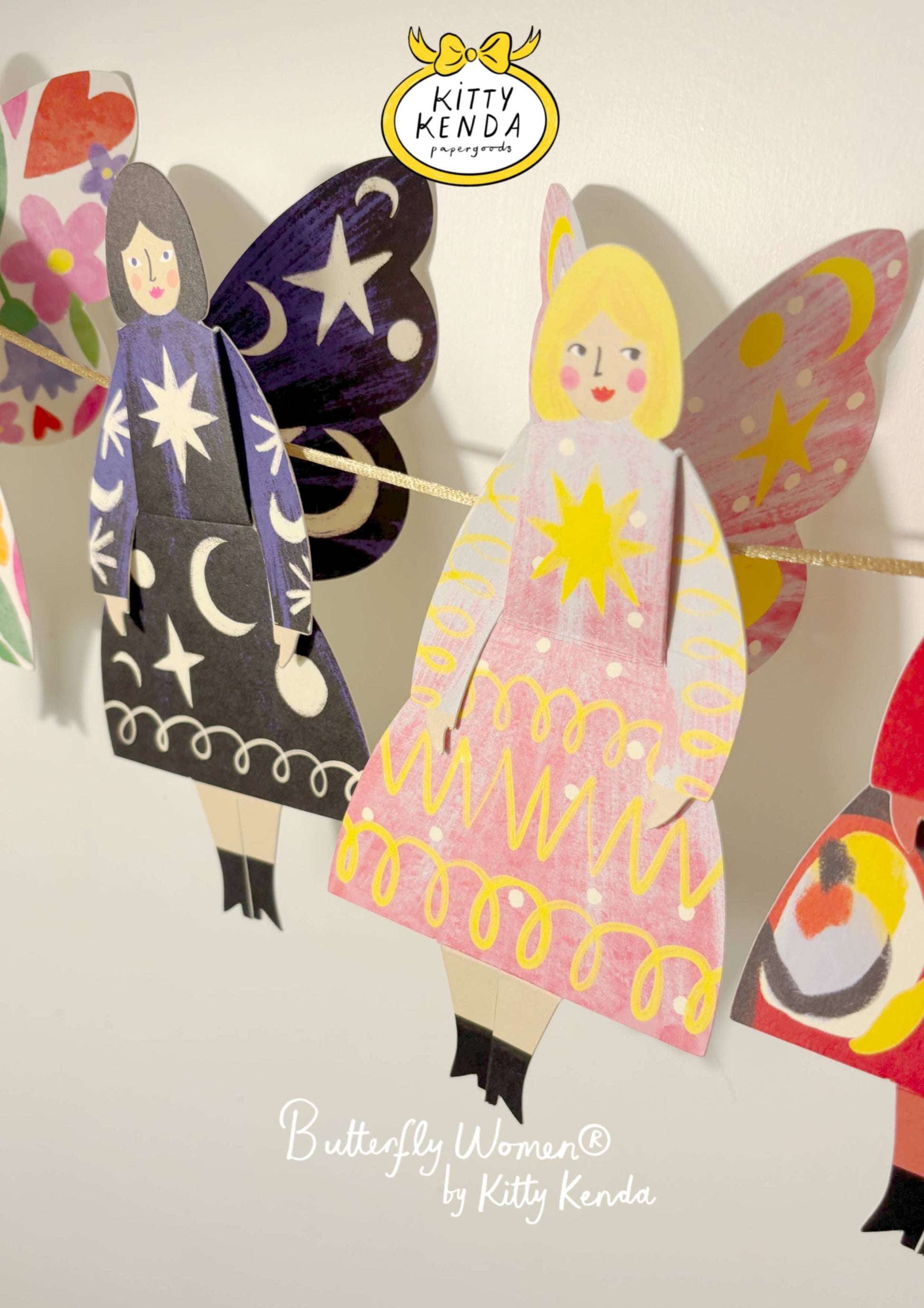Colorful paper dolls with butterfly wings and dresses, featuring the brand 'Kitty Kenda'.