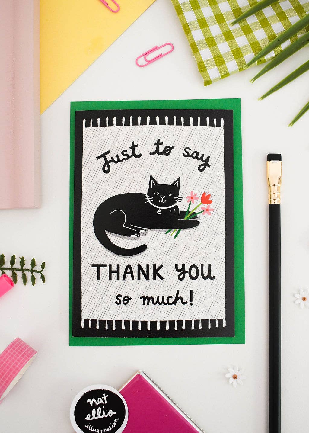 Greeting card with a black cat illustration and text on a colorful background