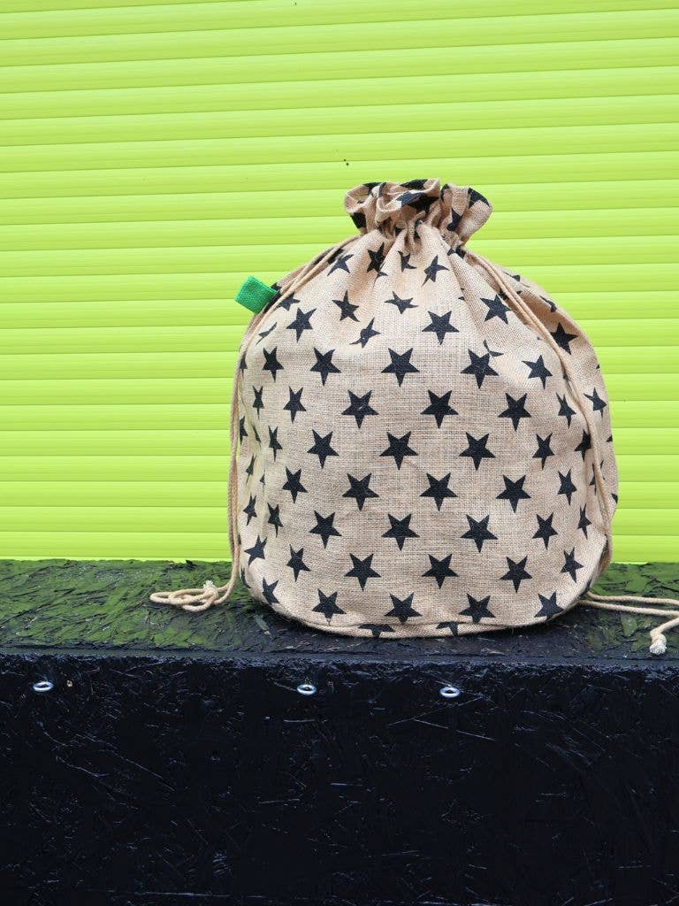 Drawstring bag with star pattern on a green background