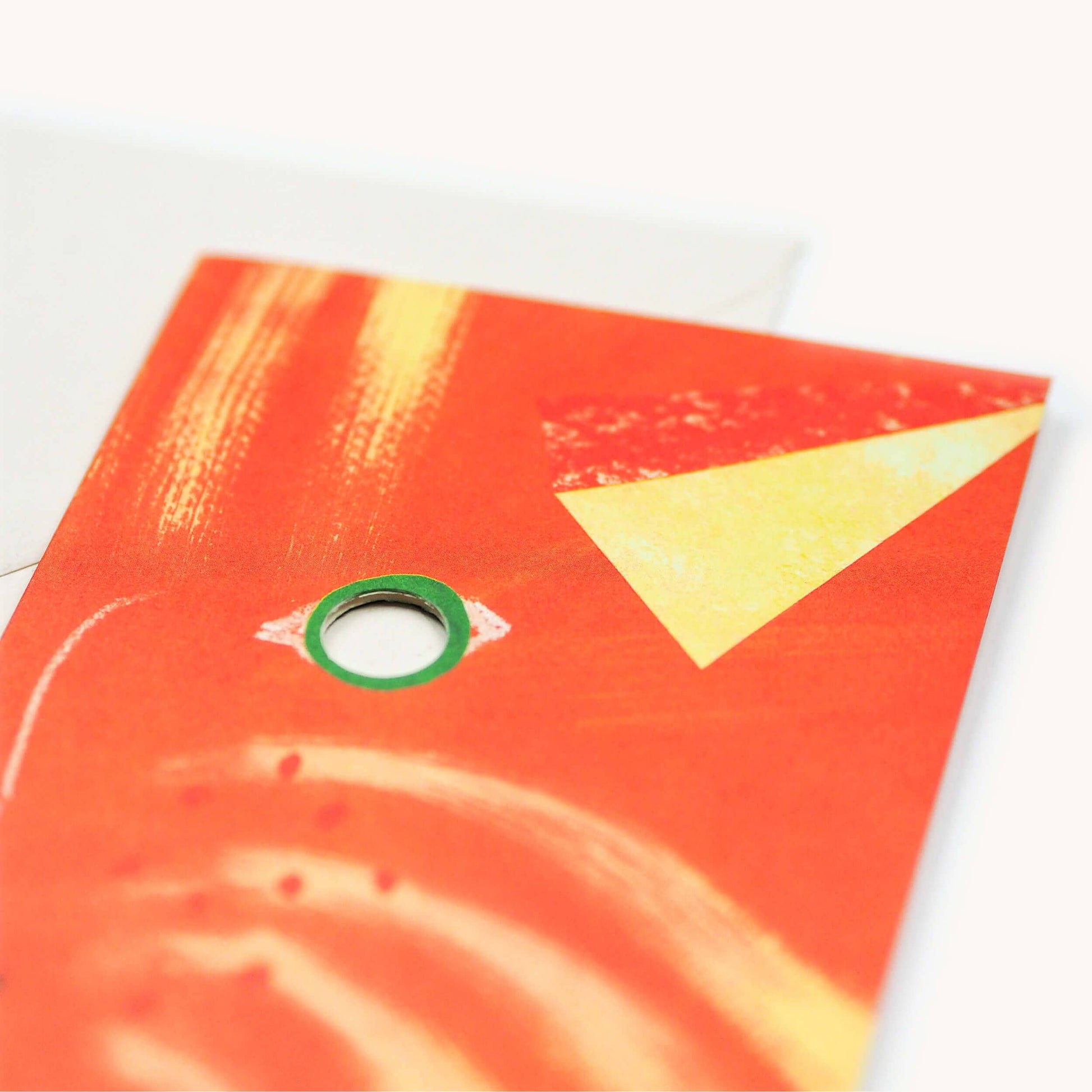 Red book cover with a yellow triangle and green circle on a white background