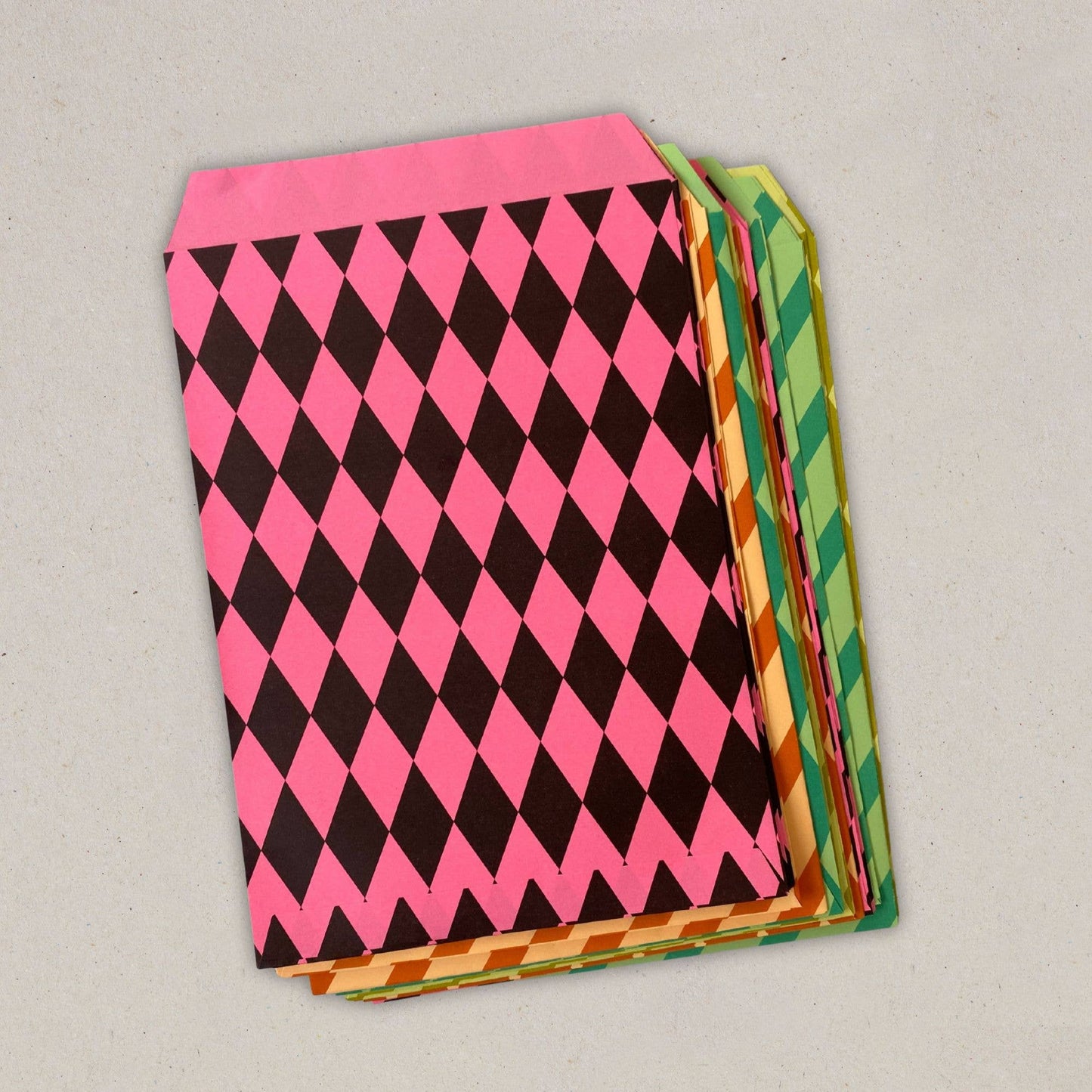 Stack of colorful patterned paper sheets on a gray background