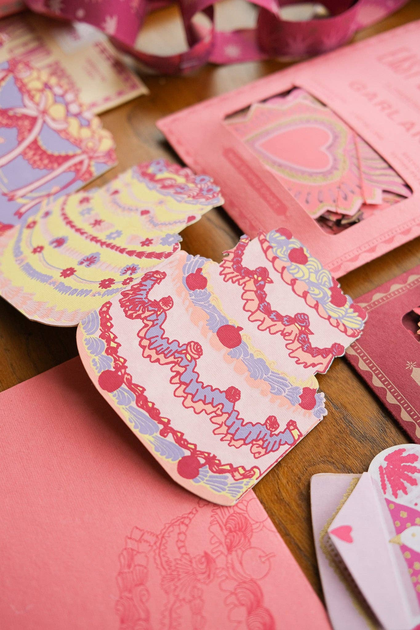 Colorful card envelopes with decorative patterns on a wooden surface