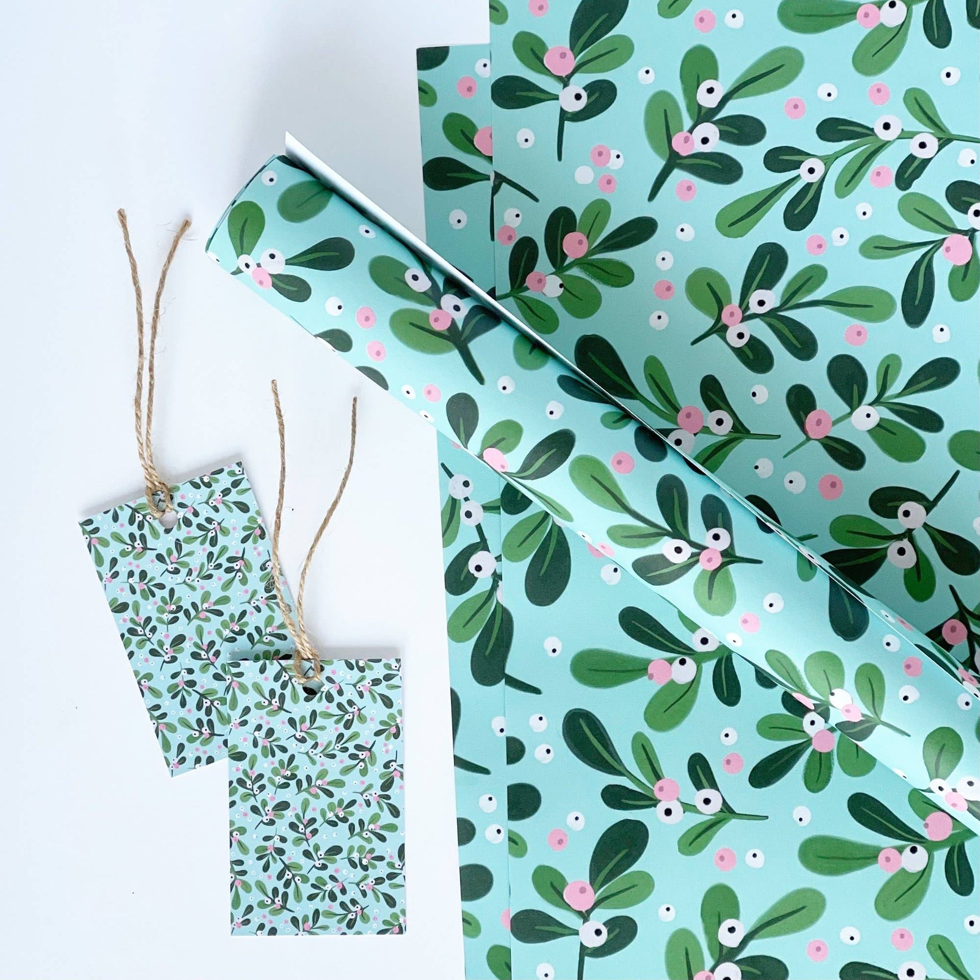 Green and pink floral patterned paper and gift tag on a white background