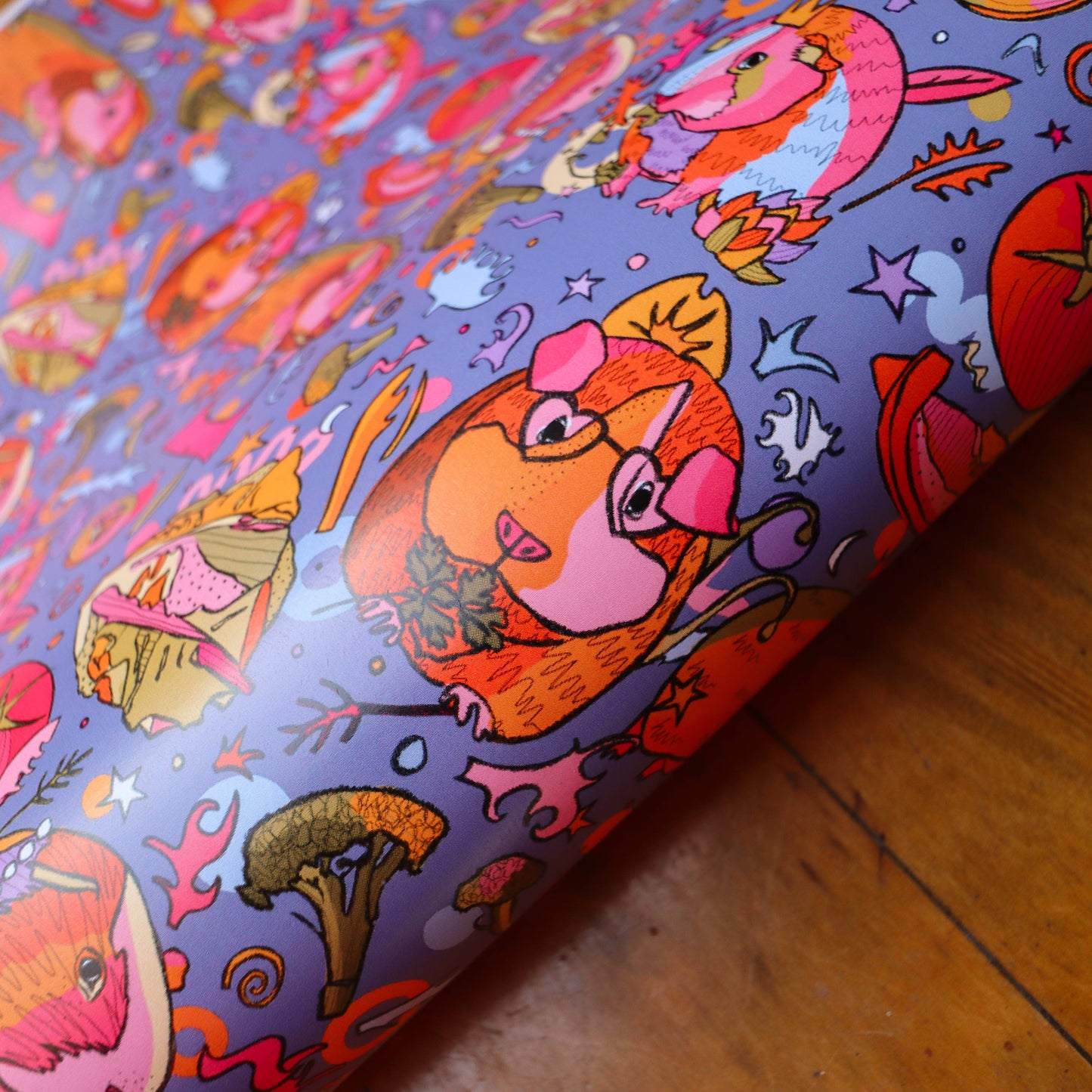 Colourful wrapping paper with guinea pigs wearing crowns.