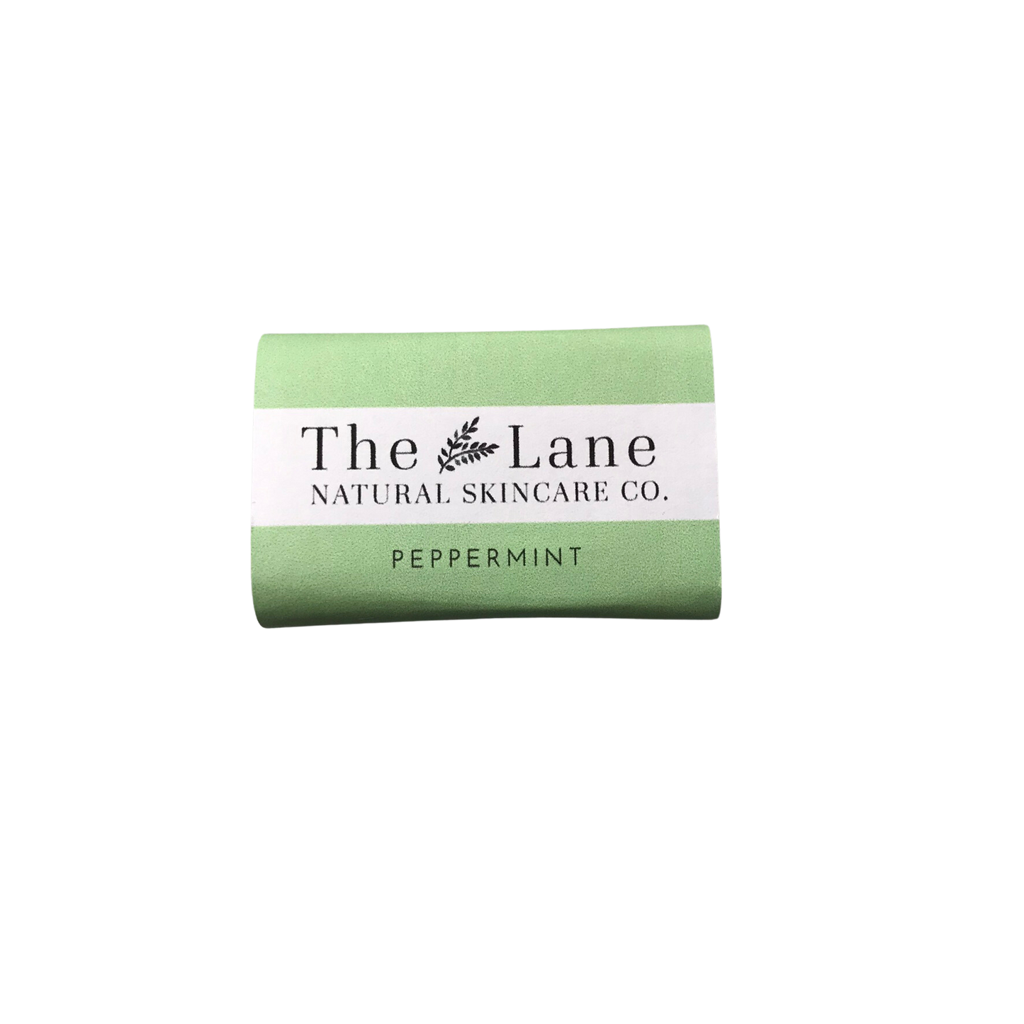 Green bar of soap with 'The Lane Natural Skincare Co.' label on a white background